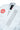 Close-up of the white AXIS Kimono by adidas collar showing the red Gracie Barra shield on the chest and gray Gracie Barra vertical logo panel on the lapel.