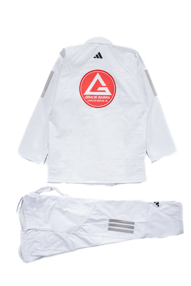 Back view of the white AXIS Kimono by adidas for Gracie Barra showing large red Barra Shield on the jacket back, adidas logo below the collar, and white pants with gray adidas stripes.