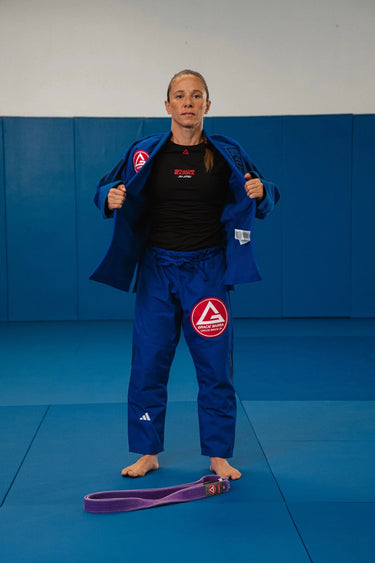 Womens blue Axis Kimono by adidas, front view with a red Barra shield chest patch and tonal Gracie Barra lapel print.