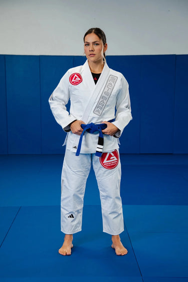 Womens Axis Kimono by adidas in white, full front view with the red Barra shield chest patch and gray Gracie Barra lapel embroidery.