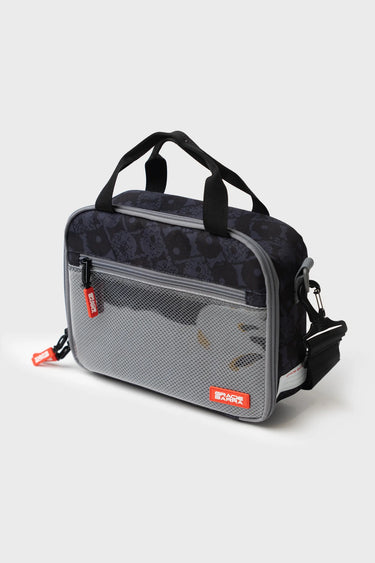 Side view of the Barra Beachwalk Lunchbox in black with mesh pocket, Gracie Barra brand tag, and attached shoulder strap