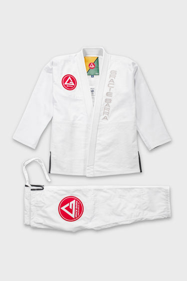 White Continuum Kimono by VG Jiu-Jitsu gi laid flat, jacket front with red Barra shield patch and GRACIE BARRA lapel embroidery, plus gi pants.