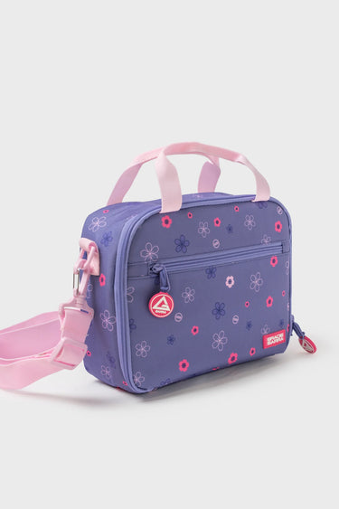 Purple Sakura Kids Lunchbox with pink floral pattern, three-quarter view showing the front zippered pocket, Gracie Barra logo patch, and pink adjustable shoulder strap.