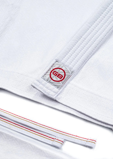 Detail of the 40 Year Anniversary Women's Kimono GB collar tag and red, gold, and white-stitched traditional draw-cord waistband