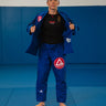 Womens blue Axis Kimono by adidas, front view with a red Barra shield chest patch and tonal Gracie Barra lapel print.