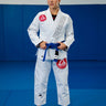 Womens Axis Kimono by adidas in white, full front view with the red Barra shield chest patch and gray Gracie Barra lapel embroidery.