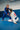 Rear view of the white Axis Womens Kimono by adidas in seated guard during training, with the red back patch and gray sleeve stripes.