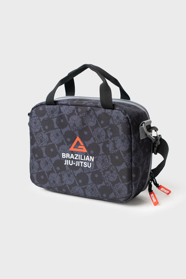 Barra Beachwalk Lunchbox in black with geometric Brazilian Jiu-Jitsu pattern, front view showing logo patch and top carry handle