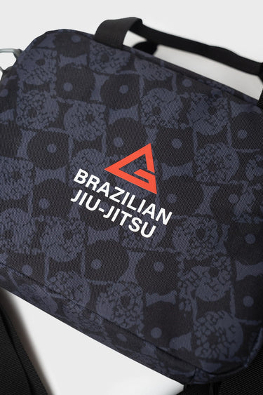 Close-up angled view of the Barra Beachwalk Lunchbox in black showing the top handle and Brazilian Jiu-Jitsu triangle logo