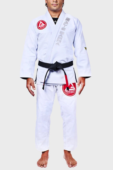 White Continuum Kimono by VG worn front view with red Barra Shield chest patch, vertical Gracie Barra lapel embroidery, and red Gracie Barra thigh patch.