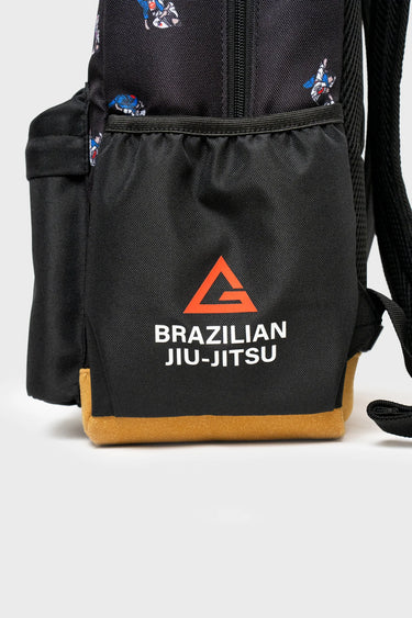 Front pocket of the Jiu-Jitsu Kids Backpack in Black/Grey with red Legacy G triangle, white Brazilian Jiu-Jitsu print & brown suede bottom panel.