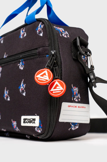 Close-up of Jiu-Jitsu lunchbox zipper pulls with rubberized Gracie Barra Red Shield and a writable name patch label