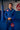 Athlete standing in a training hall wearing the full blue Ripstop Lightweight Kimono jacket and pants with a black belt and Gracie Barra chest and thigh patches