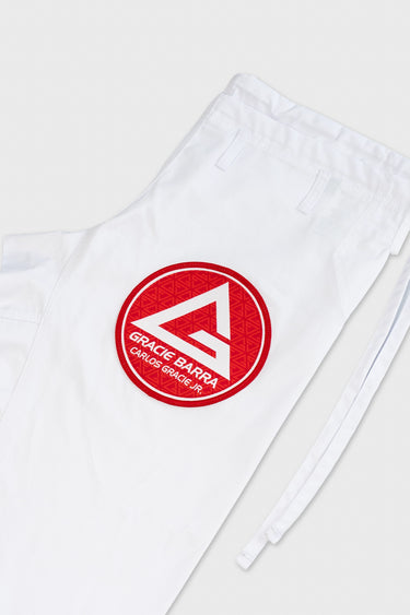 Close-up of the white ripstop kimono pants leg with embroidered red Gracie Barra circle patch