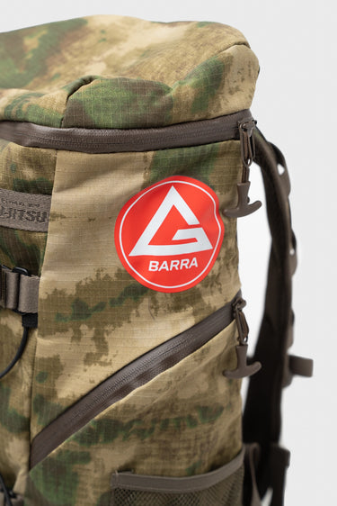 Close-up of the red Barra Shield patch on the Tactical GB4 Backpack in camo.