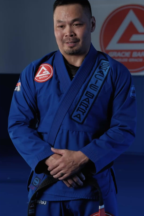 Gracie Barra Professor wearing the Ripstop kimono on the mat, giving a testimonial on the fabric and fit alongside training footage.